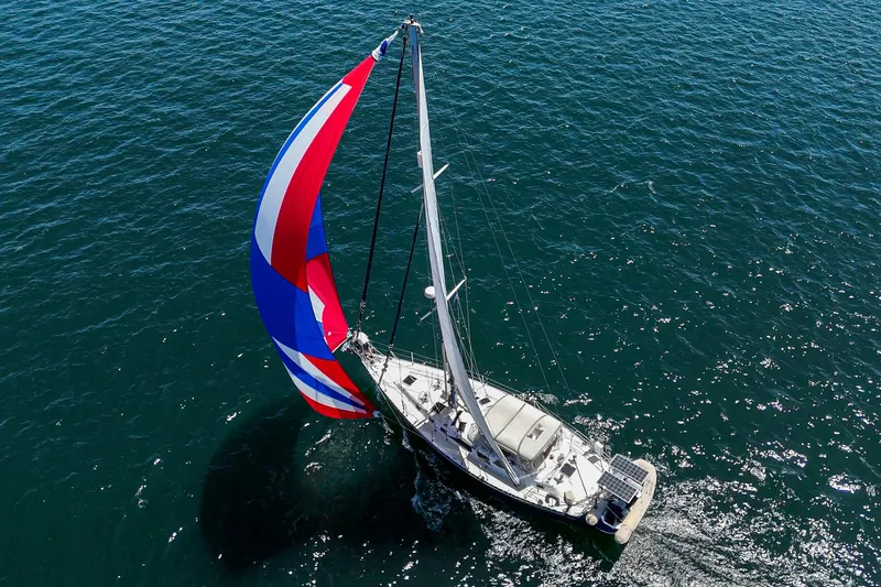 Slide: The Image of Sailing yacht Hylas 49 (2001) with colorful spinnaker on open sea. - 4