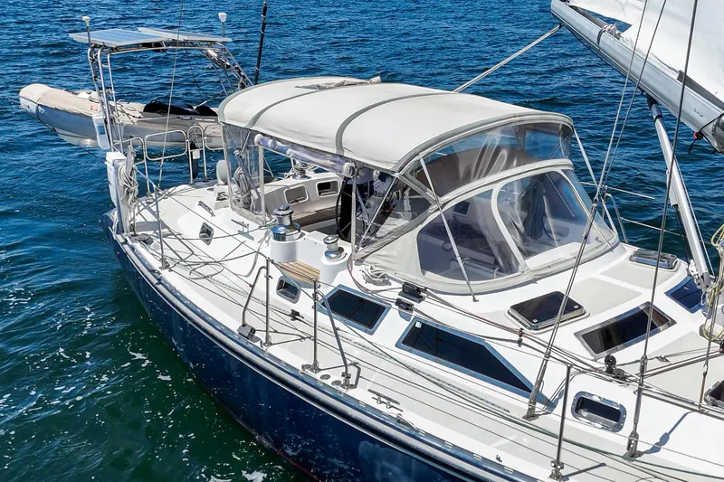 Slide: The Image of 2001 Hylas 49 sailboat with canopy, sailing on blue ocean waters. - 8