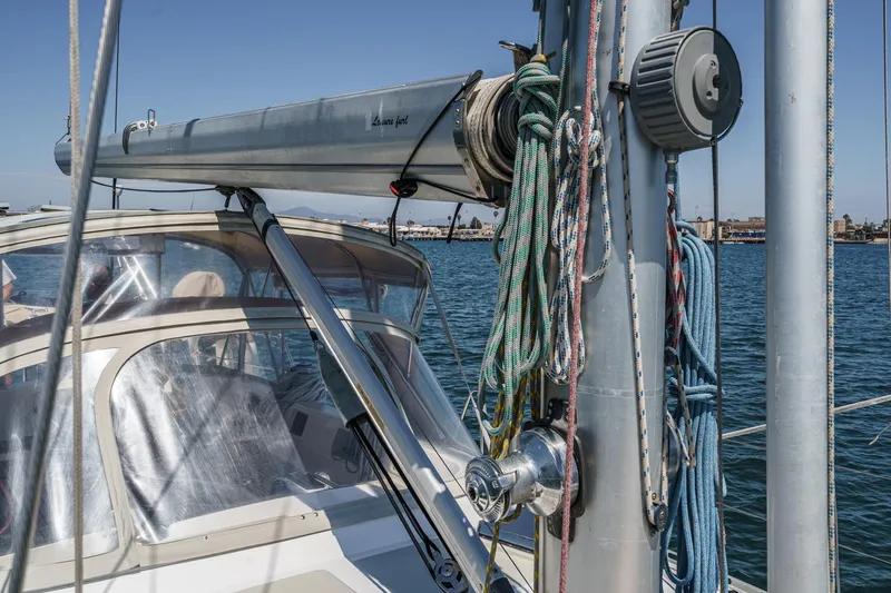 Slide: The Image of Sailboat Hylas 49, 2001 model, with rigging and ropes, docked in a marina. - 9