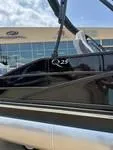 The Image of 2025 Bennington 25 QSBA boat, sleek design, docked near a modern building. - 1