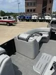 Slide: The Image of 2025 Bennington 25 QSBA pontoon boat with luxurious seating, parked outdoors. - 12