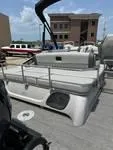 Slide: The Image of 2025 Bennington 25 QSBA pontoon boat in marina, featuring sleek design and spacious seating. - 6