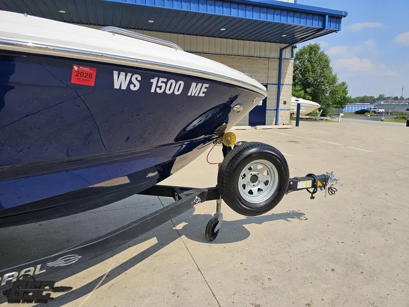 Slide: The Image of 2022 Chaparral 21 SSi boat on trailer, parked outside a building. - 10