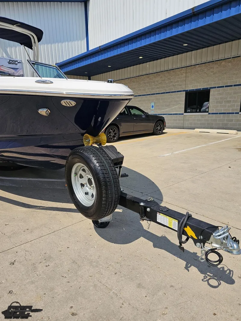 Slide: The Image of 2022 Chaparral 21 SSi boat on trailer in parking lot, sunny day. - 15