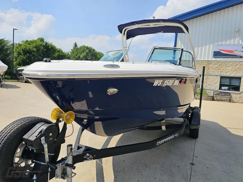 Slide: The Image of 2022 Chaparral 21 SSi boat on trailer, parked outdoors under clear sky. - 20