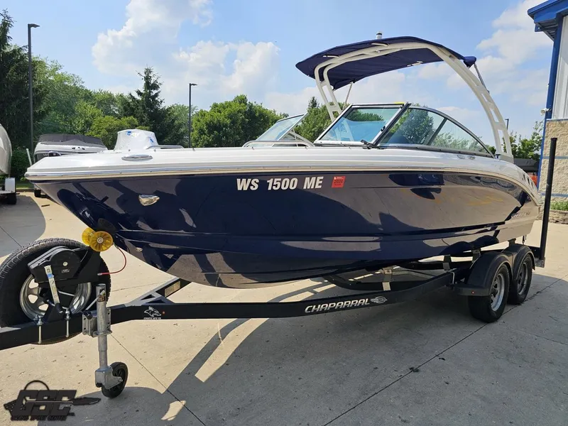 Slide: The Image of 2022 Chaparral 21 SSi boat on trailer, parked outdoors, sunny day. - 21