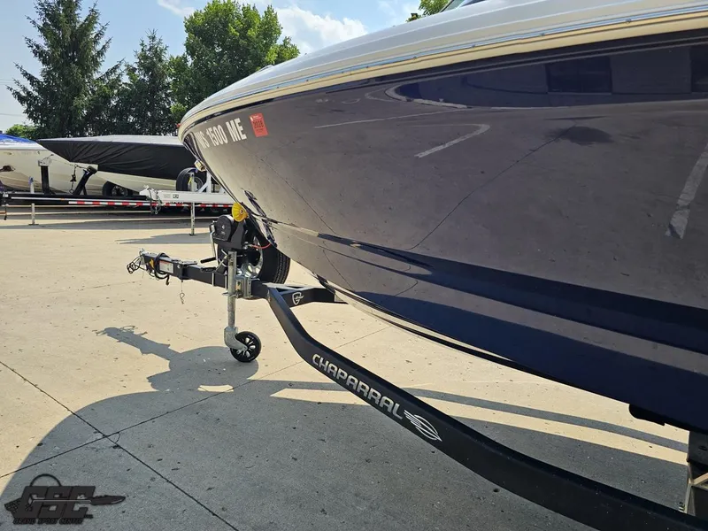 Slide: The Image of 2022 Chaparral 21 SSi boat on trailer, parked outdoors on a sunny day. - 26