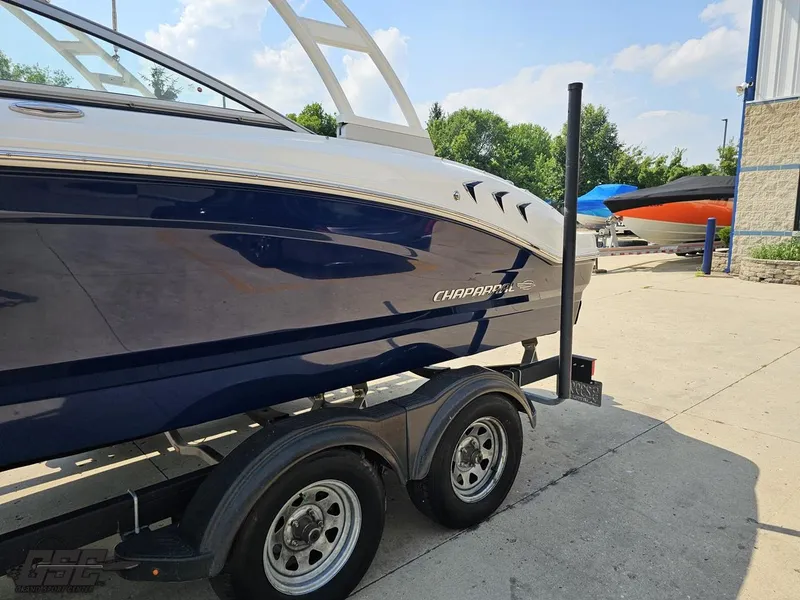 Slide: The Image of 2022 Chaparral 21 SSi boat on trailer, parked outdoors on a sunny day. - 29
