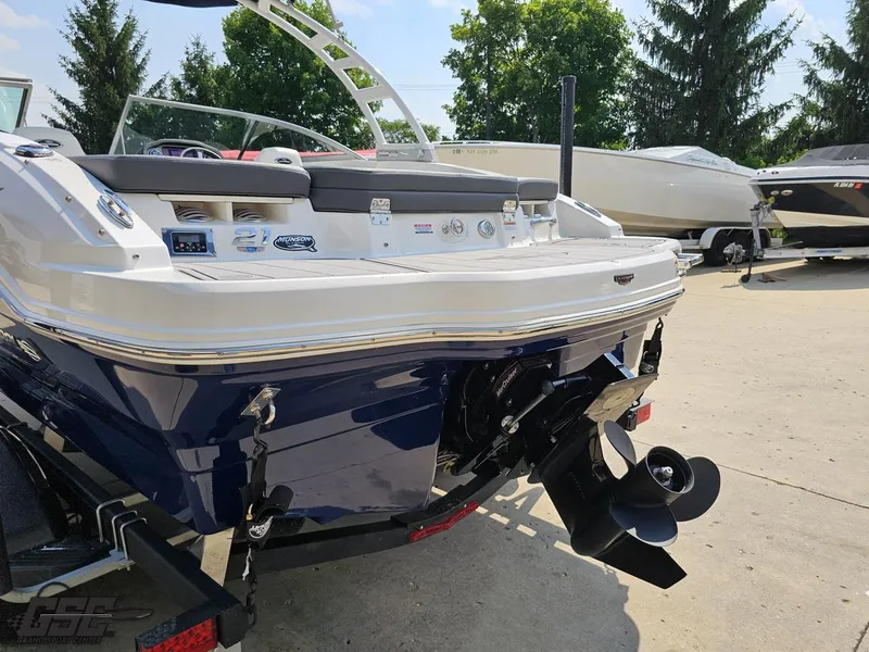 Slide: The Image of 2022 Chaparral 21 SSi boat rear view with outboard motor, parked outdoors. - 33