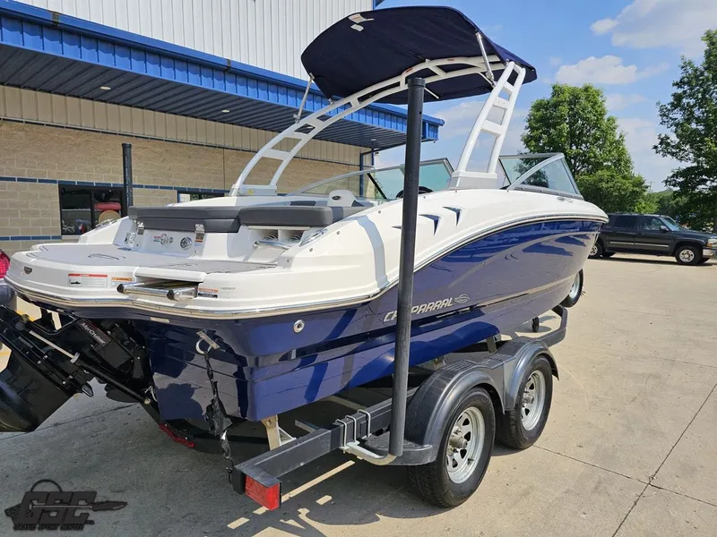 Slide: The Image of 2022 Chaparral 21 SSi boat on trailer, blue and white, parked outdoors. - 37