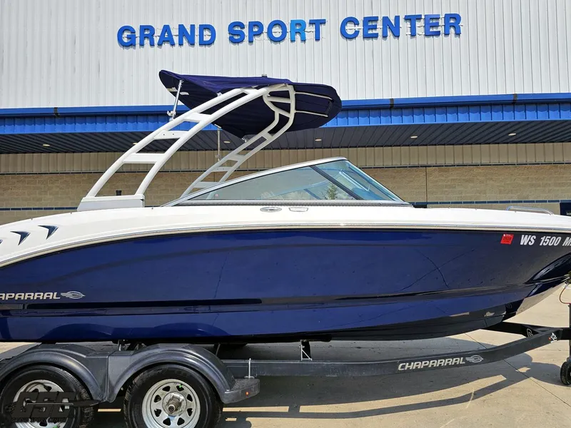 Slide: The Image of 2022 Chaparral 21 SSi boat at Grand Sport Center, featuring sleek blue and white design. - 4