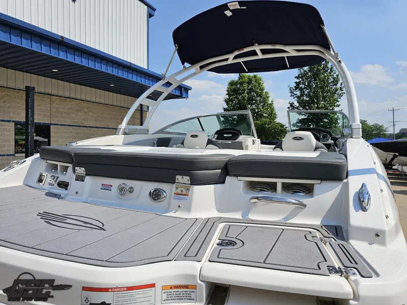 Slide: The Image of 2022 Chaparral 21 SSi boat with seating and canopy, docked outdoors. - 40