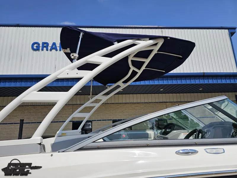 Slide: The Image of 2022 Chaparral 21 SSi boat with canopy, displayed outside a building. - 8