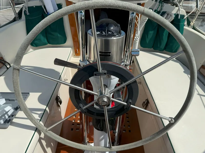 Slide: The Image of Steering wheel of a 1993 Pacific Seacraft Crealock 34 sailboat, featuring a compass. - 10
