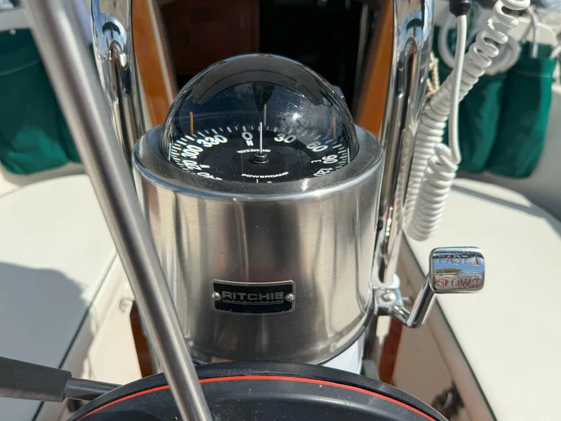 Slide: The Image of Compass and throttle controls on a 1993 Pacific Seacraft Crealock 34 sailboat. - 11