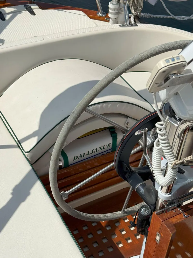 Slide: The Image of Steering wheel of 1993 Pacific Seacraft Crealock 34 sailboat, featuring "Dalliance" life ring. - 13