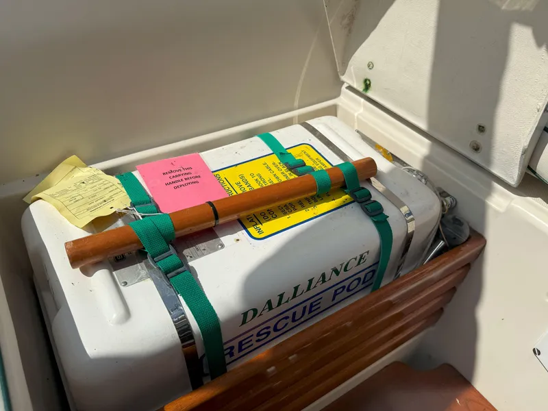 Slide: The Image of Rescue pod on 1993 Pacific Seacraft Crealock 34, secured with green straps and wooden handle. - 14