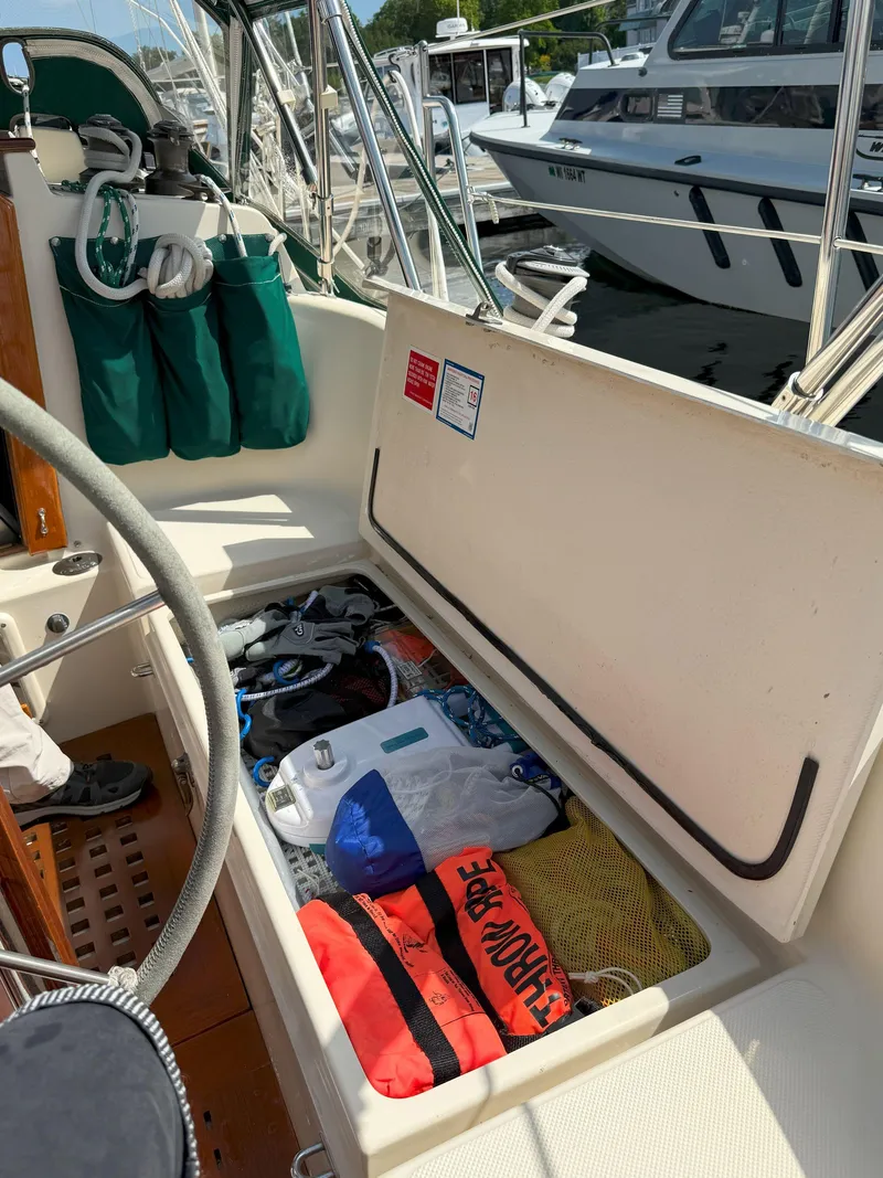 Slide: The Image of Open storage compartment on 1993 Pacific Seacraft Crealock 34 sailboat, filled with boating gear. - 15