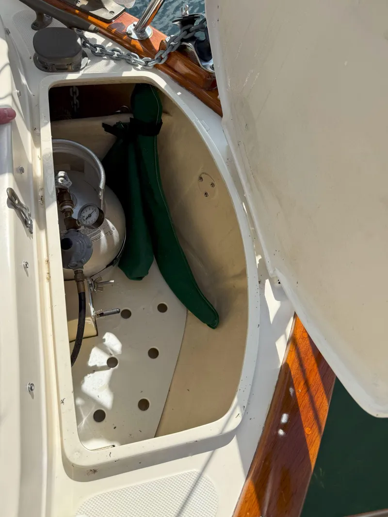 Slide: The Image of Open storage compartment on 1993 Pacific Seacraft Crealock 34 sailboat, showing propane tank and equipment. - 16