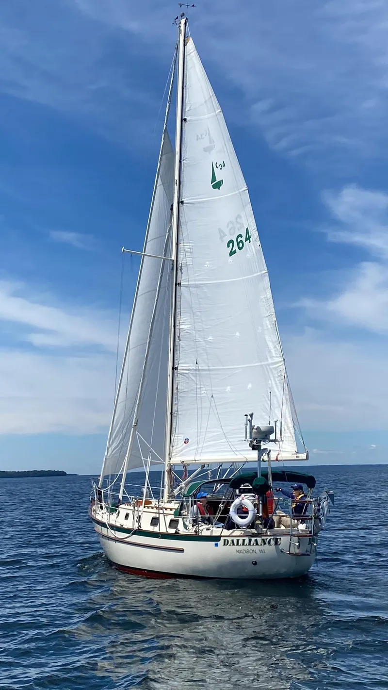 Slide: The Image of Sailboat "Dalliance" on open water, Pacific Seacraft Crealock 34, 1993 model, under clear blue sky. - 2