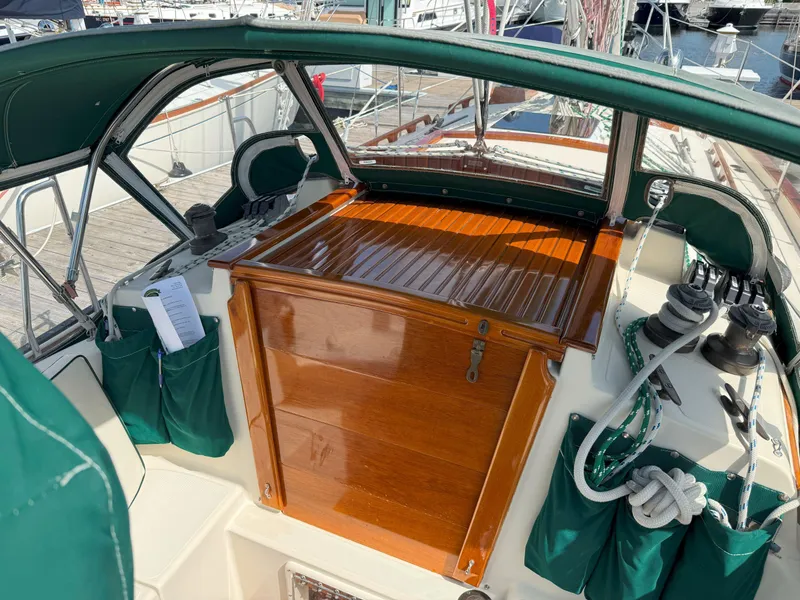 Slide: The Image of Cockpit of 1993 Pacific Seacraft Crealock 34 sailboat with green canvas and wooden hatch. - 20
