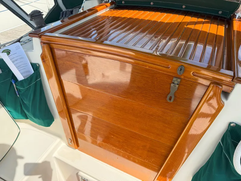 Slide: The Image of Polished wooden hatch on 1993 Pacific Seacraft Crealock 34 sailboat, with green storage pockets. - 21