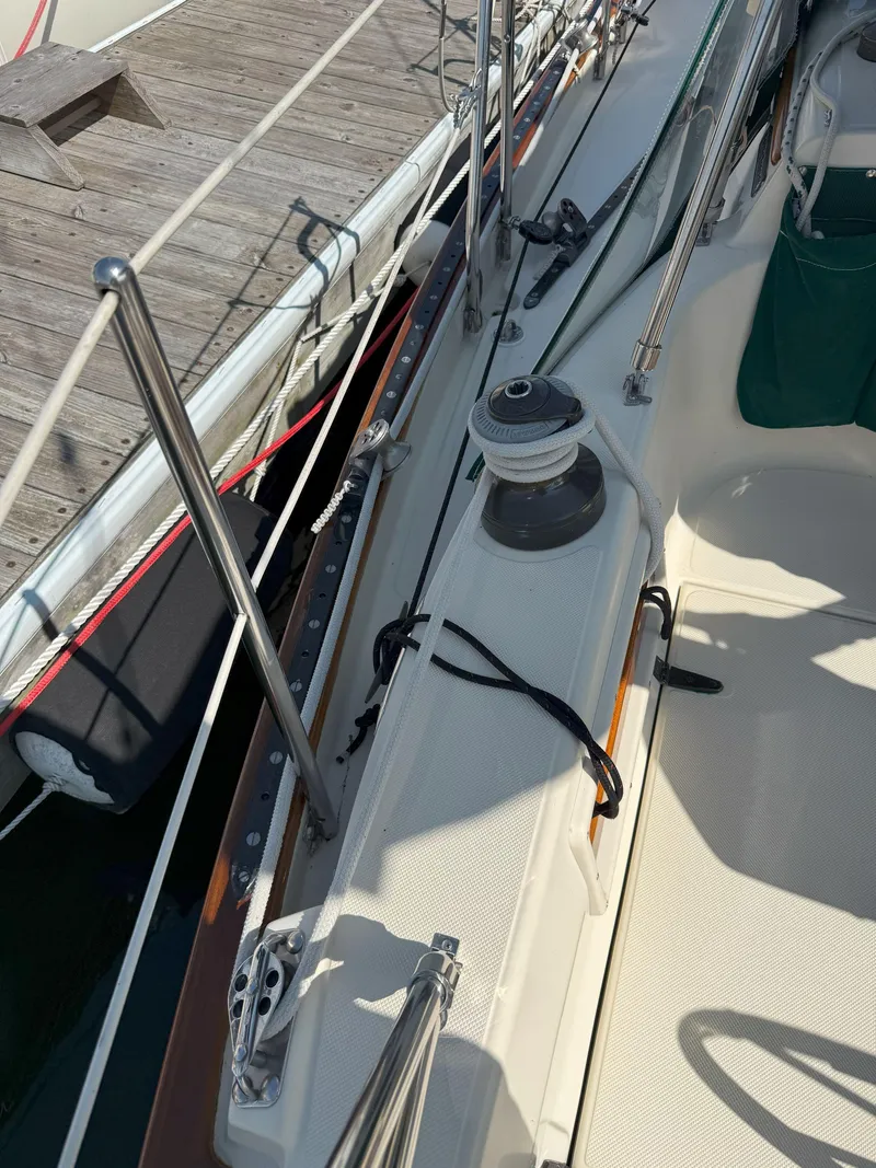 Slide: The Image of Pacific Seacraft Crealock 34 sailboat deck, 1993 model, docked with visible winch and railing. - 24