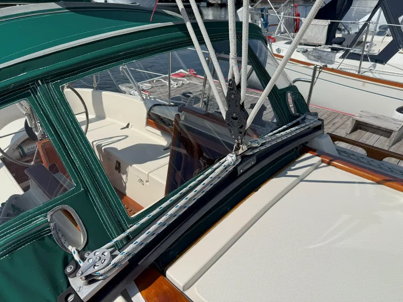 Slide: The Image of Sailboat cockpit with green canopy, rigging, and winch on a 1993 Pacific Seacraft Crealock 34. - 26