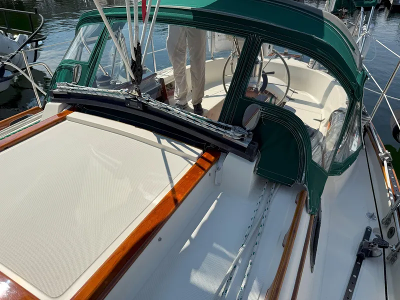 Slide: The Image of 1993 Pacific Seacraft Crealock 34 sailboat with green canopy and wooden accents. - 27