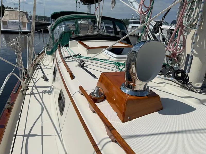 Slide: The Image of 1993 Pacific Seacraft Crealock 34 sailboat deck with polished wood and rigging. - 28