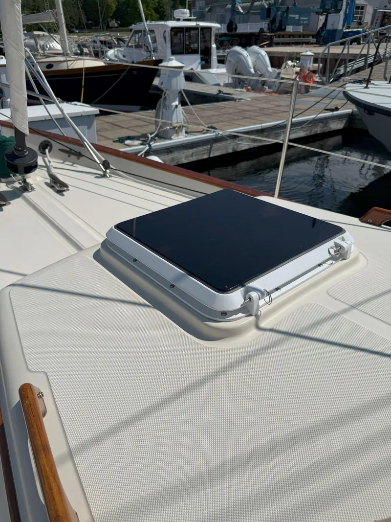 Slide: The Image of 1993 Pacific Seacraft Crealock 34 sailboat deck with hatch, docked at marina. - 37