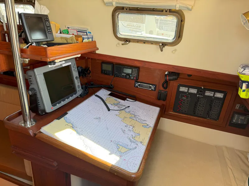 Slide: The Image of Navigation station on 1993 Pacific Seacraft Crealock 34 sailboat with chart and electronics. - 47