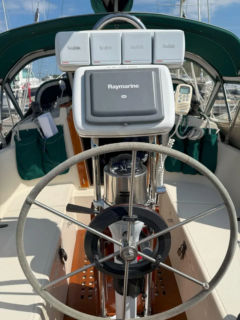 Slide: The Image of Steering wheel and navigation equipment on 1993 Pacific Seacraft Crealock 34 sailboat. - 9