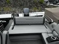 Slide: The Image of 2025 Bennington 25 QXSBA boat interior with gray seating and cup holders. - 10