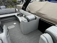Slide: The Image of 2025 Bennington 25 QXSBA boat interior with gray seating and covered area. - 6