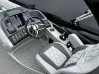 Slide: The Image of 2025 Bennington 25 QXSBA boat interior with modern dashboard and steering wheel. - 8
