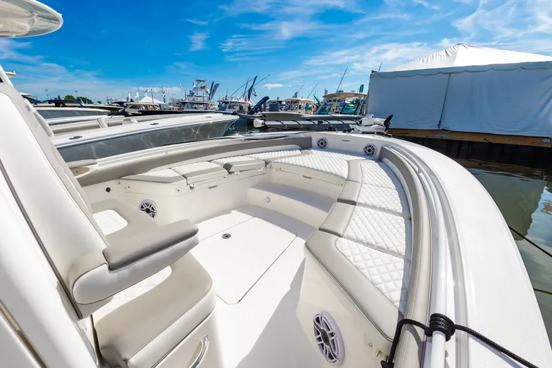 Slide: The Image of 2026 Regulator 26XO boat interior with white seating at a marina. - 12