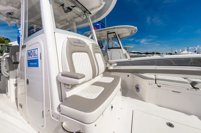 Slide: The Image of 2026 Regulator 26XO boat interior with cushioned seating and clear blue sky background. - 13