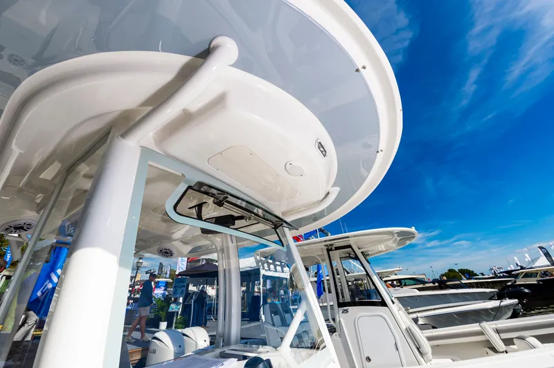 Slide: The Image of 2026 Regulator 26XO boat at a marina under a clear blue sky. - 14