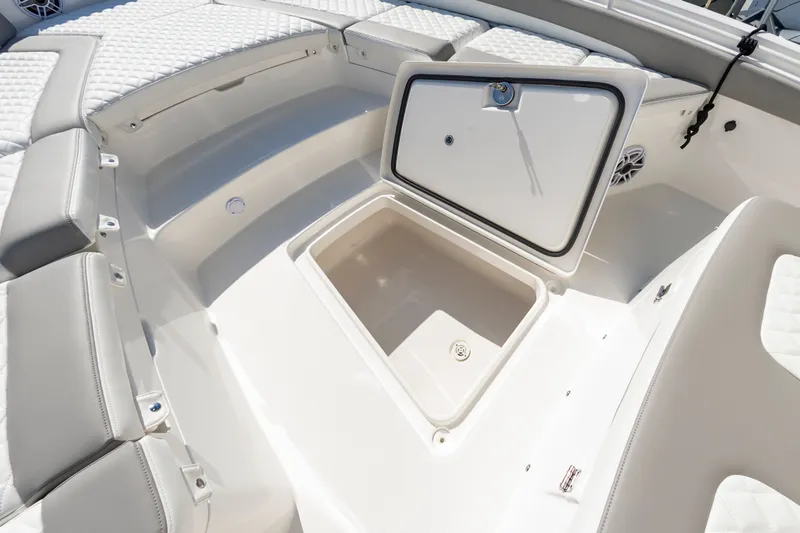 Slide: The Image of 2026 Regulator 26XO boat interior with open storage compartment and cushioned seating. - 15