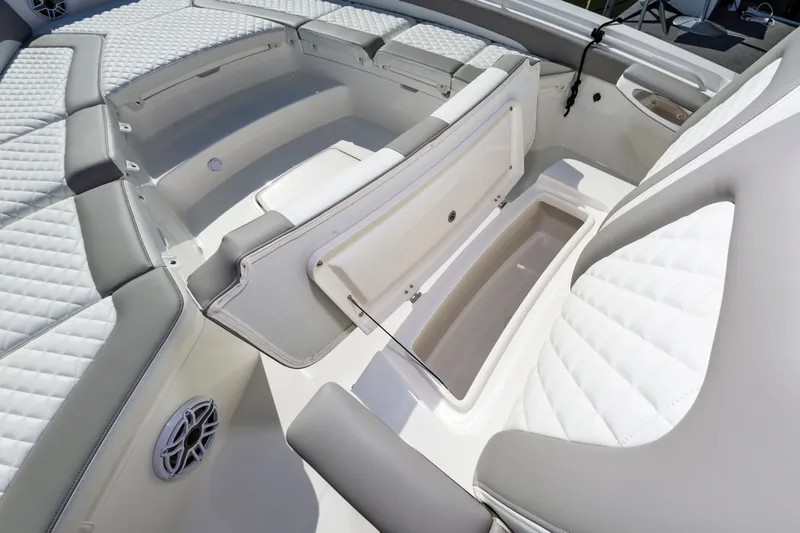 Slide: The Image of 2026 Regulator 26XO boat interior with cushioned seating and storage compartments. - 16