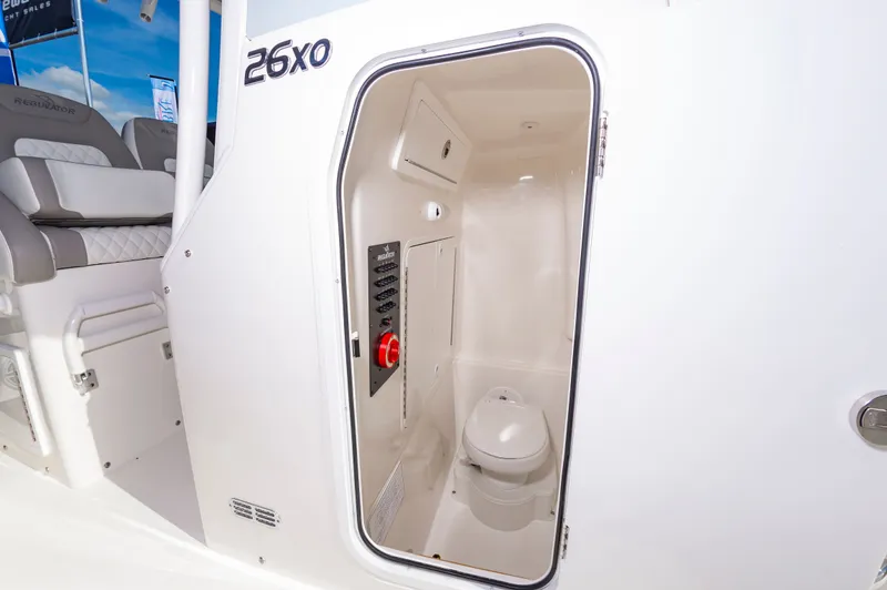 Slide: The Image of 2026 Regulator 26XO boat interior with compact marine toilet and control panel. - 18
