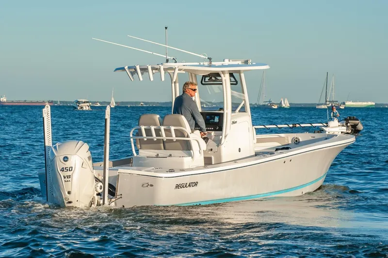 Slide: The Image of 2026 Regulator 26XO boat cruising on open water with clear skies. - 2