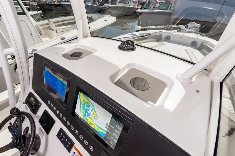 Slide: The Image of 2026 Regulator 26XO boat dashboard with navigation screens and steering wheel. - 5