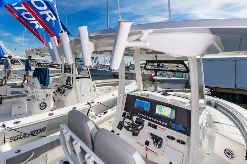 Slide: The Image of 2026 Regulator 26XO boat interior with advanced navigation system and fishing rod holders. - 7