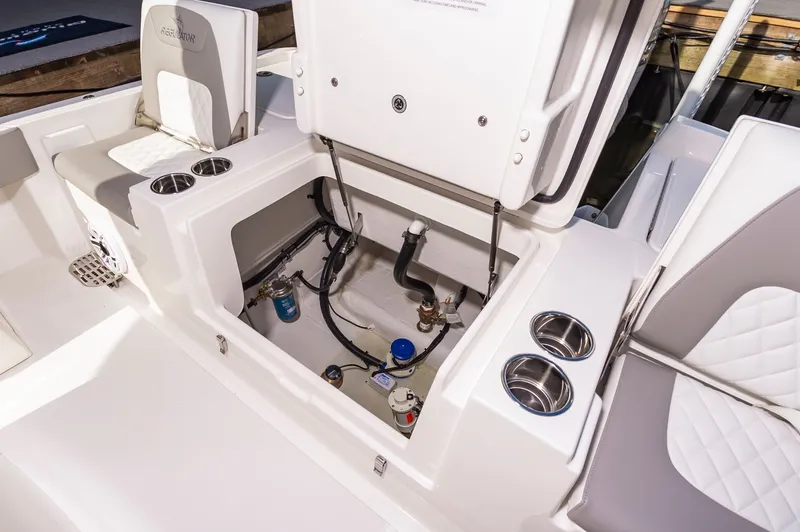 Slide: The Image of 2026 Regulator 26XO boat interior with open storage compartment and cup holders. - 9