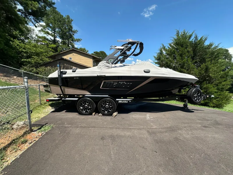 Slide: The Image of 2020 Malibu Wakesetter 23 LSV boat on trailer, covered, parked outdoors. - 1