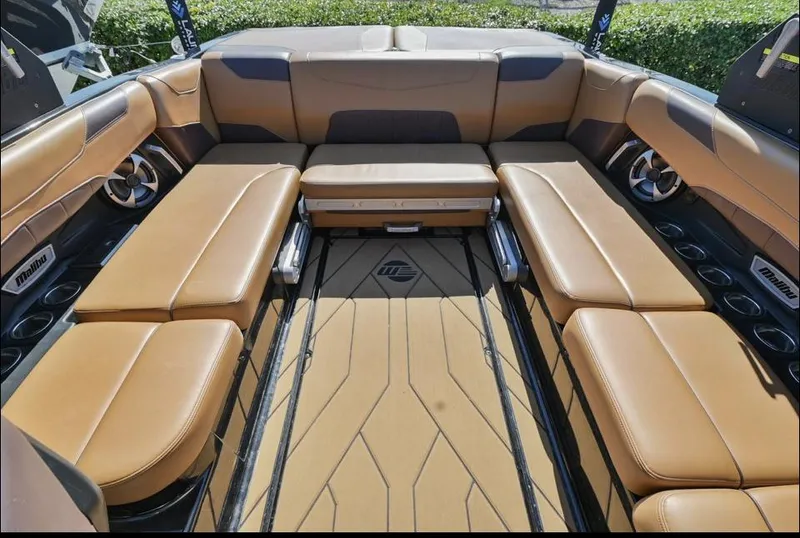 Slide: The Image of 2020 Malibu Wakesetter 23 LSV interior with tan leather seating and cup holders. - 10
