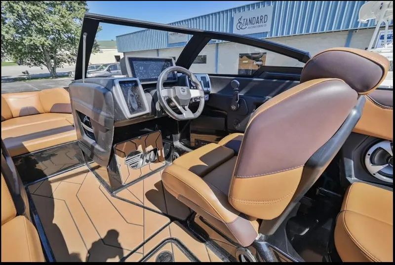 Slide: The Image of 2020 Malibu Wakesetter 23 LSV interior with brown leather seats and modern dashboard. - 11