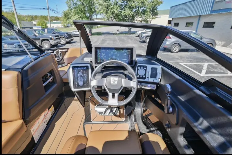 Slide: The Image of 2020 Malibu Wakesetter 23 LSV dashboard with modern controls and steering wheel. - 12